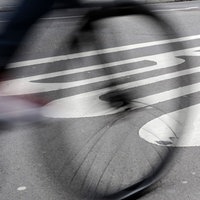 Straße mit Busspur, auf dem schemenhaft ein Fahrrad zu sehen ist