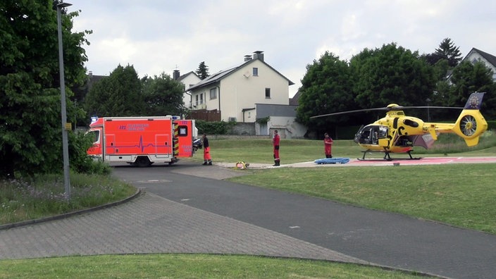 Rettungskräfte im Einsatz mit Krankenwagen und Helikopter