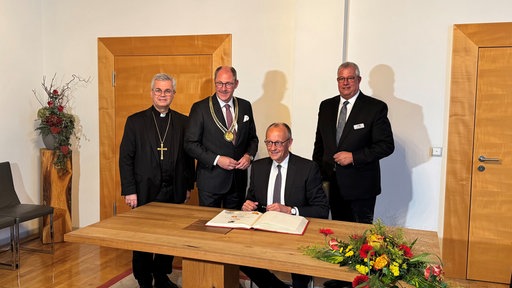 Merz trägt sich ins goldene Buch Paderborns ein