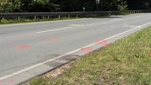 Unfallstelle am Straßenrand, die durch Markierungen gekennzeichnet ist.