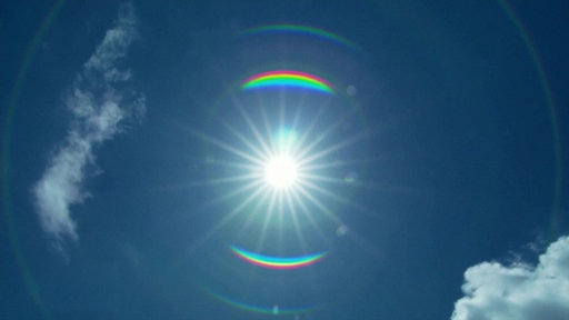 Die Sonne strahlt am leicht bewölkten Himmel