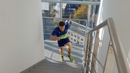 Ein Läufer rennt die Treppen hoch. 