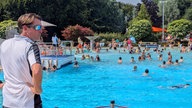 Ein Schwimmmeister überblickt ein Becken im Freibad Verl.
