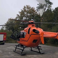 Ein Helikopter und ein Feuerwehrfahrzeug im Wald