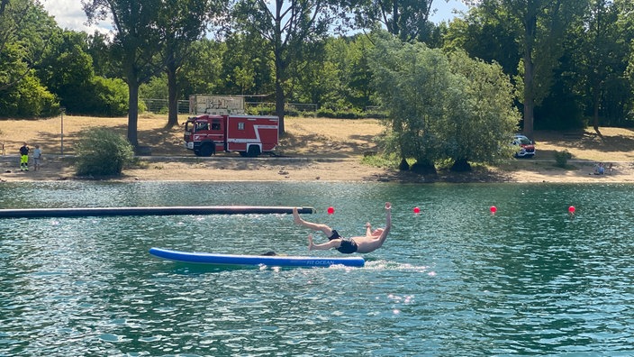 Das Bild zeigt einen gestellten Badeunfall, bei dem ein Mann ins Wasser fällt.