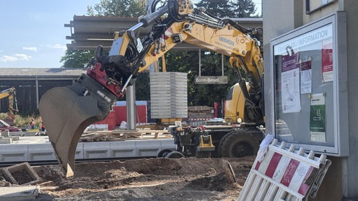 Ein Bagger arbeitet im Bereich der Gleise am Bahnhof in Beuel