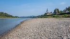 Eine Sandbank im Vordergrund, dahinter der historische Gefängnisturm in Unkel