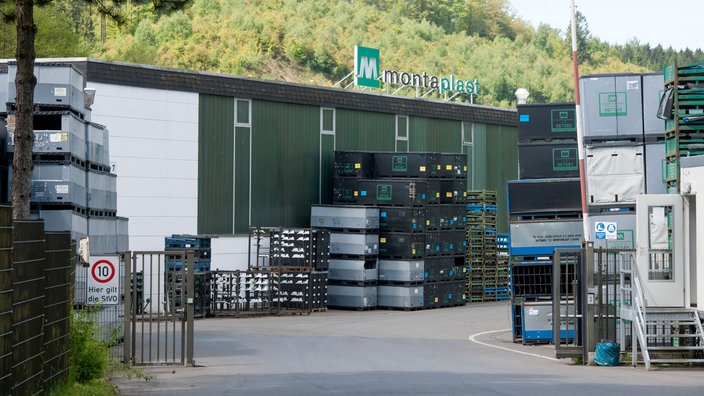 Offener Schlafbaum, dahinter Fabrikgebäude mit Schriftzug Montaplast