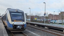 Ein blau-silberner Zug steht auf einem Gleis im Bahnhof Kleve