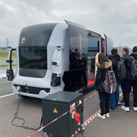 Personen steigen in ein voll automatisiertes Fahrzeug