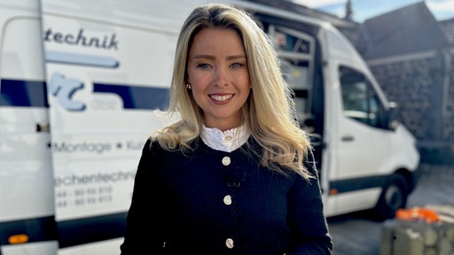 Anne Sophie Hochschützky, eine junge Frau mit blonden Haaren, lächelt in die Kamera.