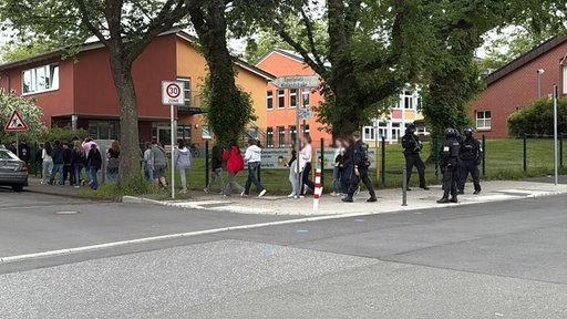 Polizisten führen Schüler aus der Heinrich-Böll Gesamtschule in Bochum