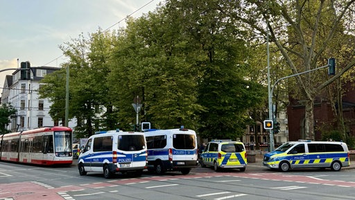 Eine Bahn und mehrere Polizeiwagen stehen vor der Pauluskirche in Duisburg