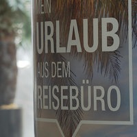 In einem Reisebüro in Gelsenkirchen, das Kunden betrogen haben soll, steht ein Schild mit der Aufschrift "Mein Urlaub aus dem Reisebüro"