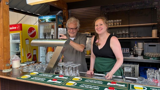 Walter Dörnemann mit seiner Tochter hinter der Theke 