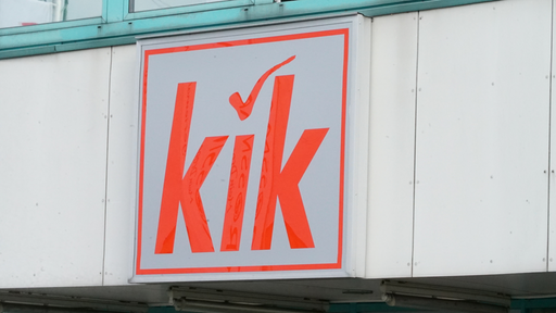 Roter Schriftzug von KiK auf grauem Schild