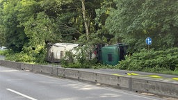 Ein Laster liegt seitlich umgekippt in einem Straßengraben bei Gladbeck