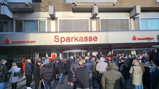 Größere Menschenmenge von Sparkassenfiliale