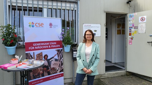 Frau vor Container