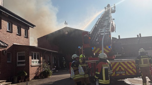 Ein brennender Stall wird von der Feuerwehr gelöscht