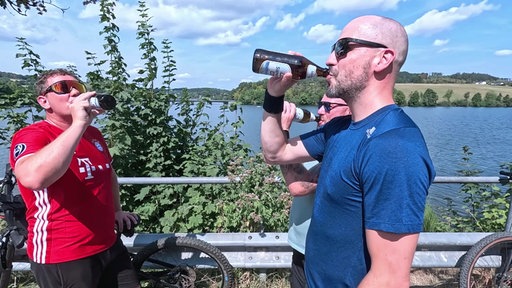 Drei junge Familienväter gönnen sich drei Bier nach ihrer Fahrradtour