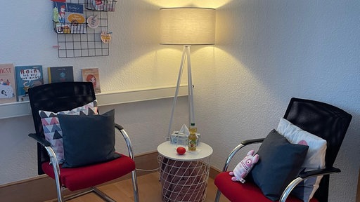 Eine Sitzecke mit Kinderbüchern an der Wand.