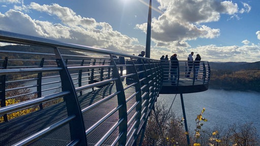 Viele Menschen stehen am Skywalk am Biggesee