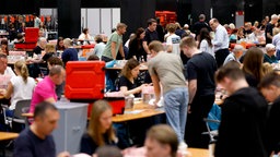 Briefwahlunterlagen zur Kommunalwahl in NRW liegen im Briefwahlzentrum Köln auf Tischen in Kisten. 