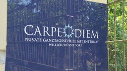 Schild mit der Aufschrift "Carpe Diem private Ganztagsschule mit Internat"