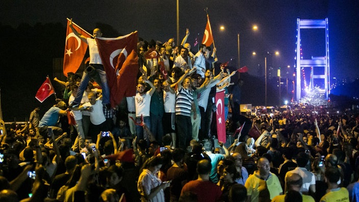 Menschen mit der Flagge der Türkei an der Fatih Sultan Mehmet Brücke