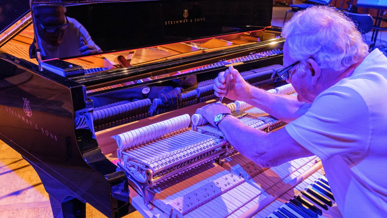 Aufnahme von der Gala des Klassik Forums im Kölner Funkhaus: Ein Mann stimmt ein Klavier.