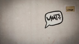 Das Graffito einer Sprechblase mit der Inschrift "What?" an einer Wand.