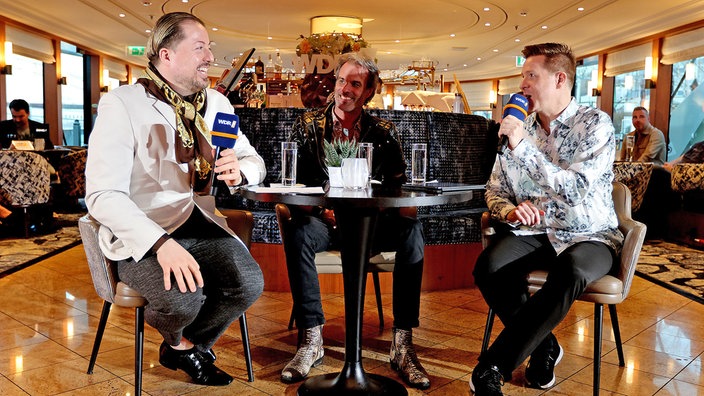 Bastian Bender (r.) interviewt Bastian Korn (m.) und Cruise Director an Bord der Viva Tiara