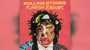 Das Cover des Albums "Foreign Tongues" von den Rolling Stones zeigt eine comichafte, karikatur-artige Collage aus den Gesichtern von Mick Jagger, Keith Richards und Ron Wood vor rosarotem Hintergrund