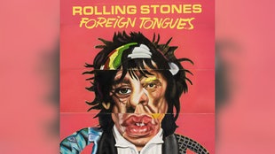 Das Cover des Albums "Foreign Tongues" von den Rolling Stones zeigt eine comichafte, karikatur-artige Collage aus den Gesichtern von Mick Jagger, Keith Richards und Ron Wood vor rosarotem Hintergrund