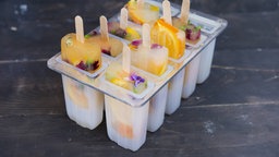 Selbstgemachtes Eis am Stiel mit diversen Früchten in einer Form zum Einfrieren.
