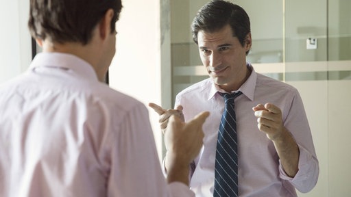 Man smiling at his reflection in mirror