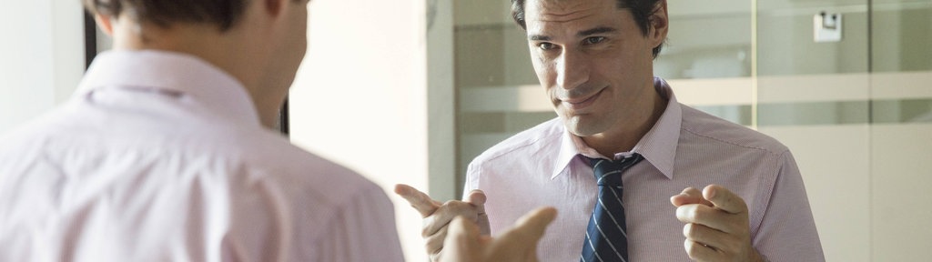 Man smiling at his reflection in mirror