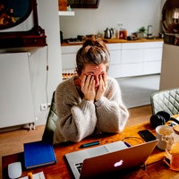 working from home burnout anxiety stress a woman is looking for a job and has her hands in her hair
