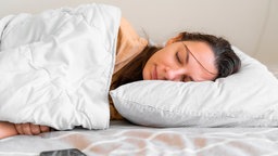 Young woman goes to sleep Phone addiction, insomnia. try to fall asleep. Sleep tracking on the phone. Circadian rhythm.