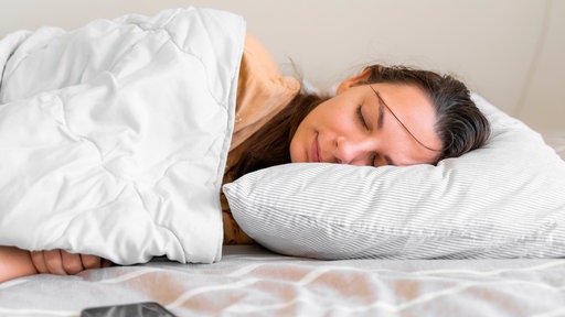 Young woman goes to sleep Phone addiction, insomnia. try to fall asleep. Sleep tracking on the phone. Circadian rhythm.