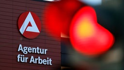 Eine rote Ampel vor dem Arge-Logo an der Agentur für Arbeit