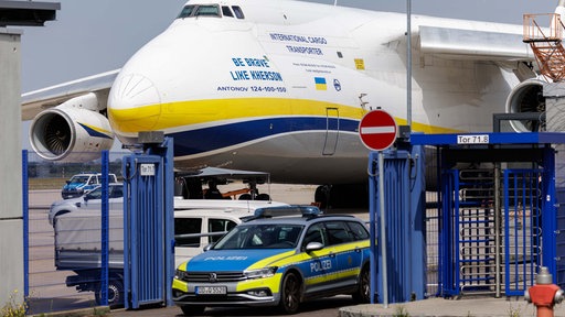 Polizeiwagen vor einem ukrainischen Flugzeug am Flughafen Leipzig (05.08.2026).