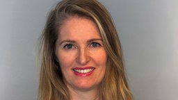 Eine Portraitaufnahme von Ursina Donatsch, die sie mit freundlichem Lächeln zeigt.