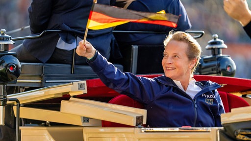 Isabell Werth schwingt eine Deutschlandfahne bei der Abschlussfeier der Reit-WM
