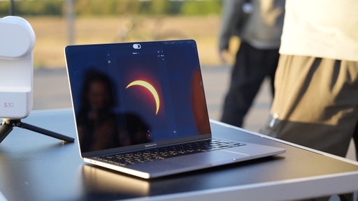 Die Sonnenfinsternis zusehen auf einem Laptop-Bildschirm