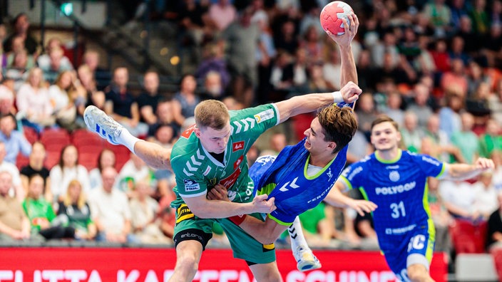 Karolis Antanavicius von GWD Minden umd Duell mit Julian Köster vom VfL Gummersbach.