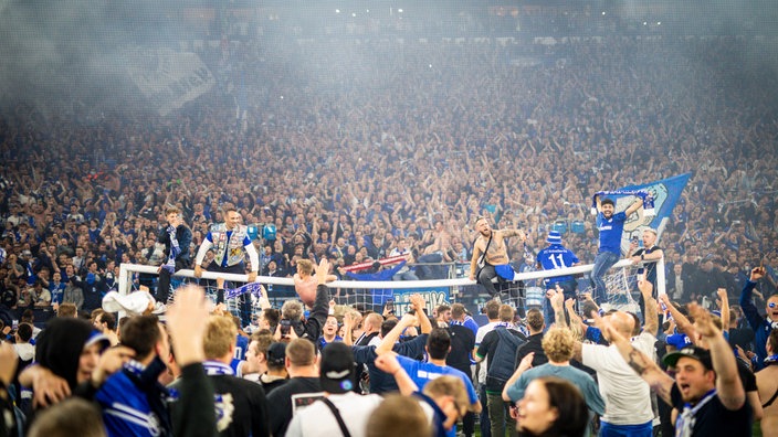 Schalke-Fans feiern nach dem Aufstiegsspiel gegen St. Pauli im Innenraum