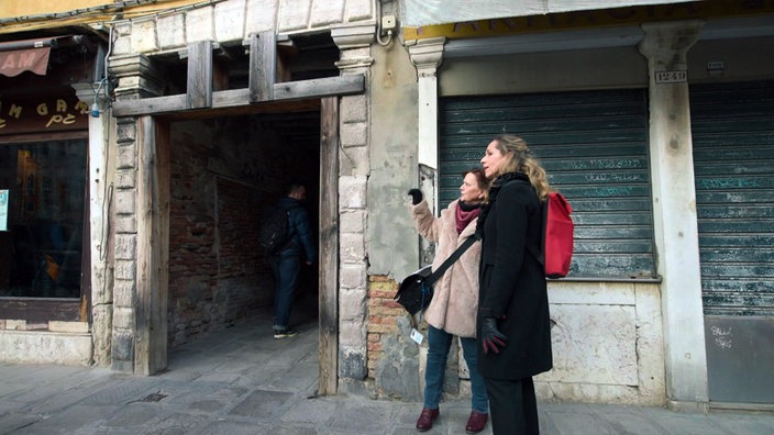 Tamina Kallert (r) und Ute Mathews-Werk stehen vor dem Tor ins ehemalige Ghetto von Venedig.