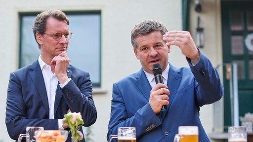 Hendrik Wüst (l, beide CDU), Ministerpräsident von Nordrhein-Westfalen, und Sven Schulze, Ministerpräsident von Sachsen-Anhalt, sprechen während eines Bürgergesprächs
